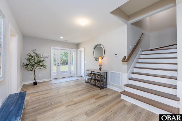 foyer featuring recessed lighting, visible vents, stairway, wood finished floors, and baseboards