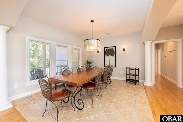 dining room featuring ornate columns, baseboards, visible vents, and light wood-style flooring