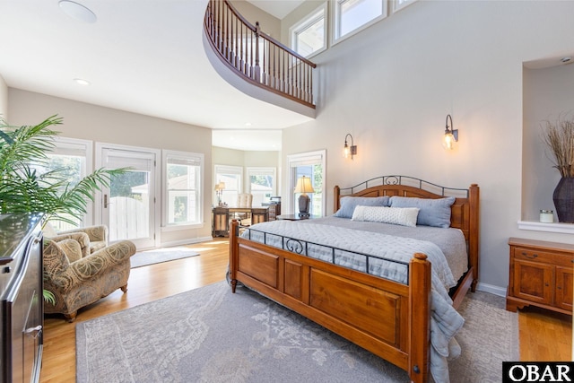 bedroom with light wood-type flooring, baseboards, and recessed lighting