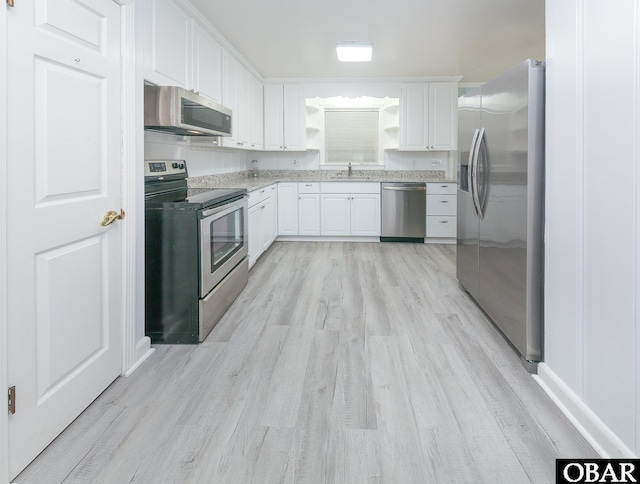 202 Winfall Blvd, Hertford, NC 27944 - kitchen featuring stainless steel appliances, light wood finished floors, white cabinets, and open shelves