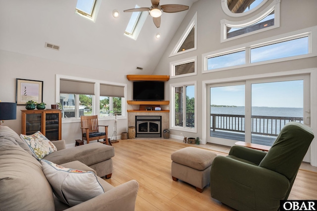 103 King Edward Ct Lot 13, Kill Devil Hills, NC 27948 - living room with high vaulted ceiling, a ceiling fan, a tile fireplace, light wood-type flooring, and recessed lighting
