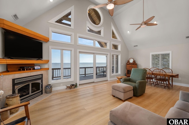 103 King Edward Ct Lot 13, Kill Devil Hills, NC 27948 - living room with high vaulted ceiling, ceiling fan, a tiled fireplace, wood finished floors, and recessed lighting