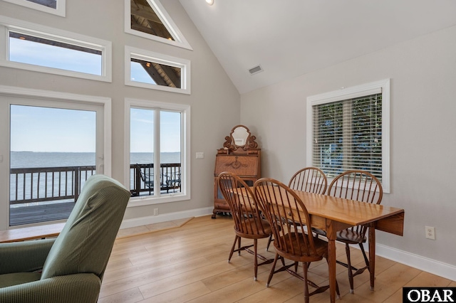 103 King Edward Ct Lot 13, Kill Devil Hills, NC 27948 - dining space featuring baseboards, high vaulted ceiling, light wood-type flooring, and a water view