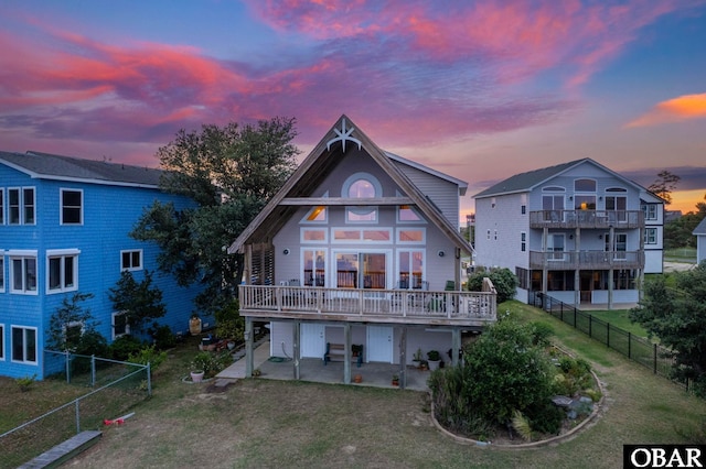 103 King Edward Ct Lot 13, Kill Devil Hills, NC 27948 - back of property at dusk with a patio and a wooden deck