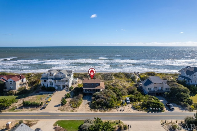 aerial view featuring a water view, a residential view, and a beach view