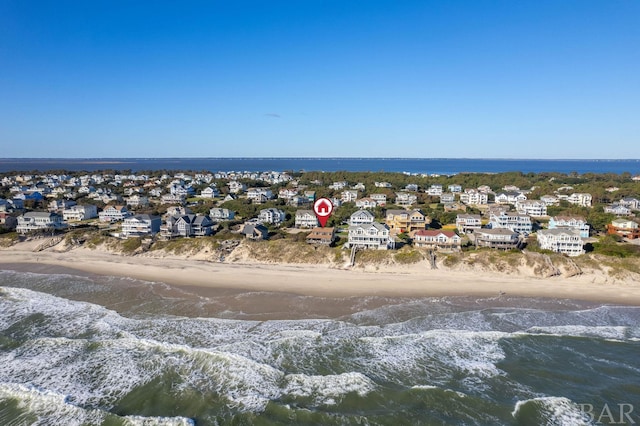 birds eye view of property with a water view, a residential view, and a beach view