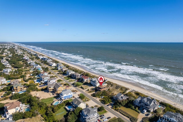 birds eye view of property with a residential view, a water view, and a beach view