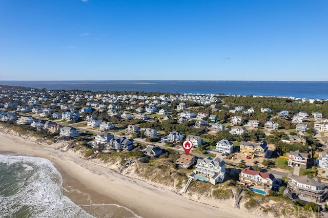 birds eye view of property with a water view, a residential view, and a beach view