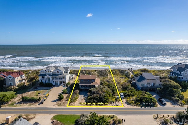 birds eye view of property with a view of the beach, a water view, and a residential view