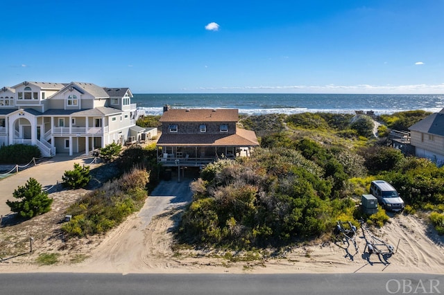 birds eye view of property featuring a water view and a view of the beach