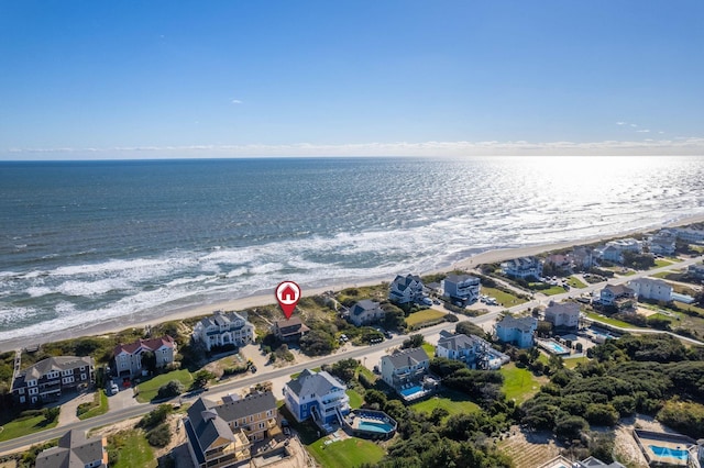 birds eye view of property with a beach view and a water view