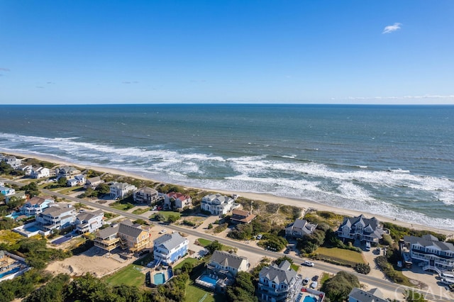 bird's eye view with a view of the beach, a water view, and a residential view