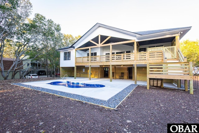 back of house with a patio area and an outdoor pool