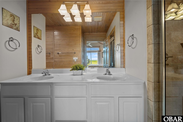 full bath with double vanity, a sink, a tile shower, and wooden ceiling