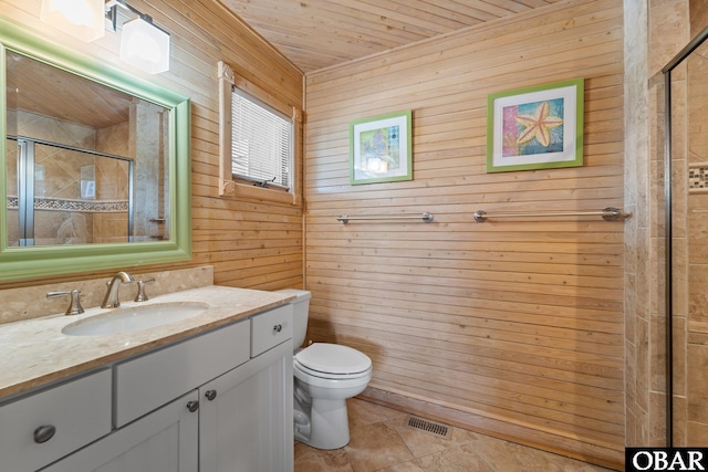 bathroom featuring wooden ceiling, a tile shower, wood walls, and toilet
