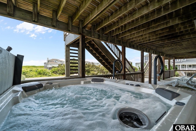 view of patio / terrace with a hot tub and a wooden deck