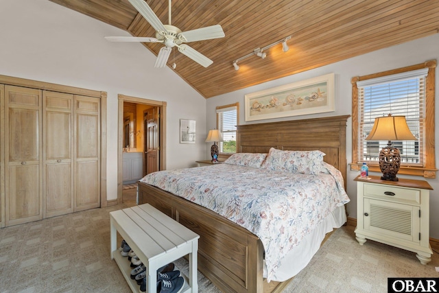 bedroom with wood ceiling, ceiling fan, lofted ceiling, light carpet, and ensuite bath