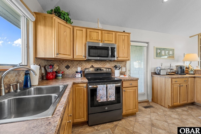 kitchen featuring a sink, light countertops, stainless steel appliances, tasteful backsplash, and visible vents