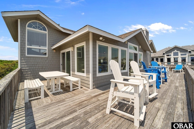 wooden terrace featuring outdoor dining area