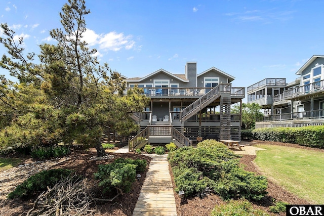 back of house featuring a deck and stairway