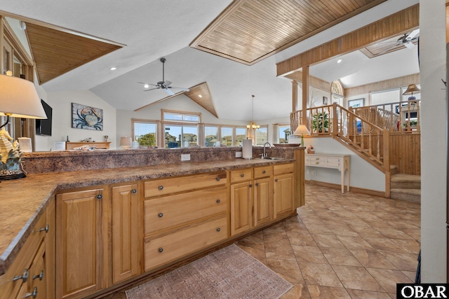 kitchen featuring a sink, ceiling fan, vaulted ceiling, and recessed lighting