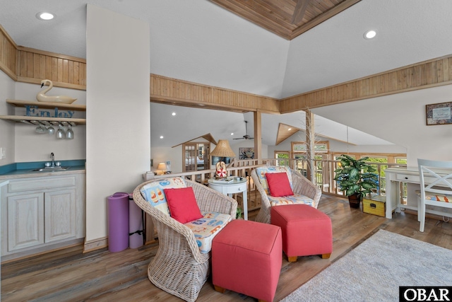 living room featuring ceiling fan, recessed lighting, wet bar, and wood finished floors