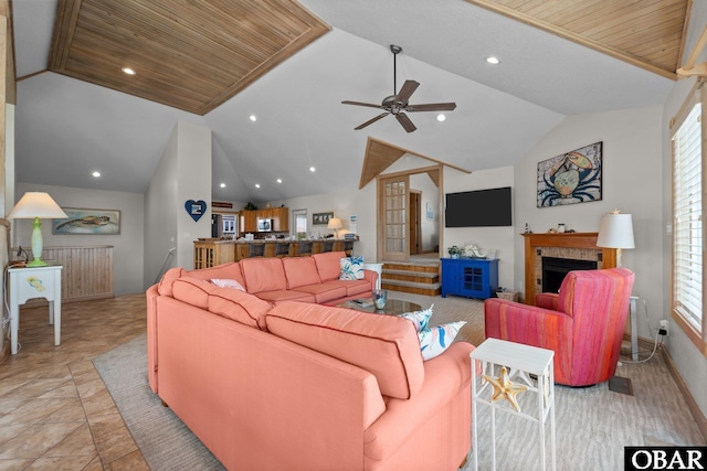living area featuring recessed lighting, a ceiling fan, lofted ceiling, and a tile fireplace