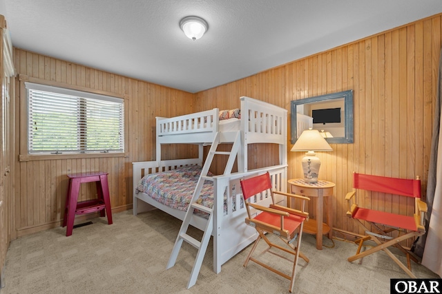 carpeted bedroom with wood walls