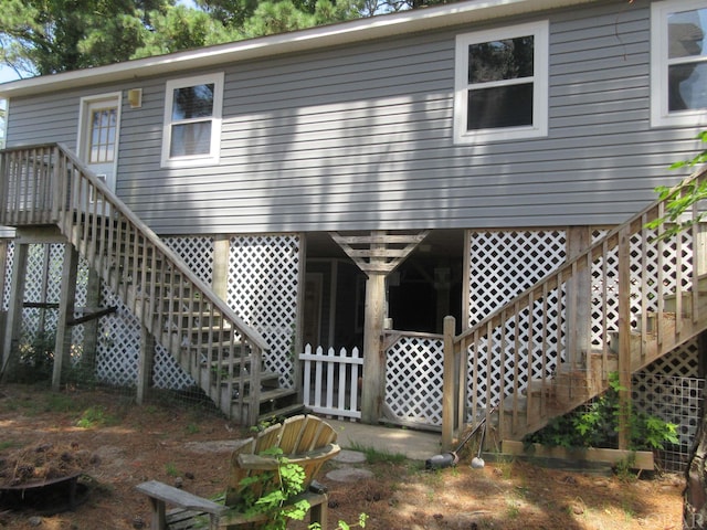 rear view of property featuring stairway