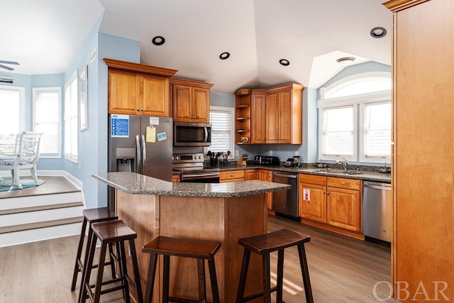 kitchen with open shelves, appliances with stainless steel finishes, dark wood-style flooring, and a sink