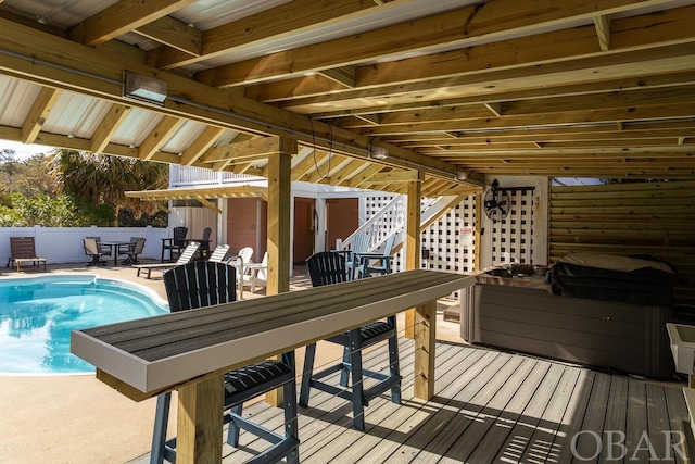 wooden terrace featuring fence and a fenced in pool