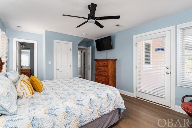 bedroom with baseboards, visible vents, ceiling fan, dark wood-style flooring, and access to exterior