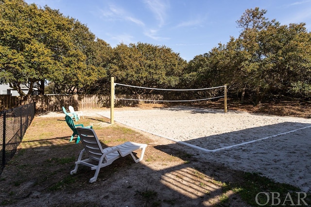 view of home's community with fence and volleyball court