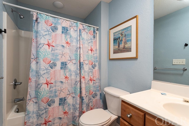 bathroom featuring shower / bath combo, a textured wall, vanity, and toilet