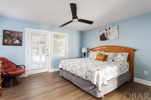 bedroom featuring baseboards, ceiling fan, wood finished floors, and access to exterior