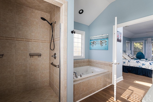 bathroom with connected bathroom, lofted ceiling, wood finished floors, a shower stall, and a bath