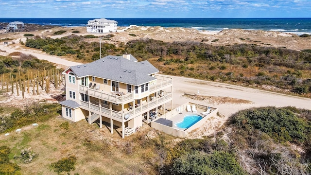 aerial view with a water view and a beach view