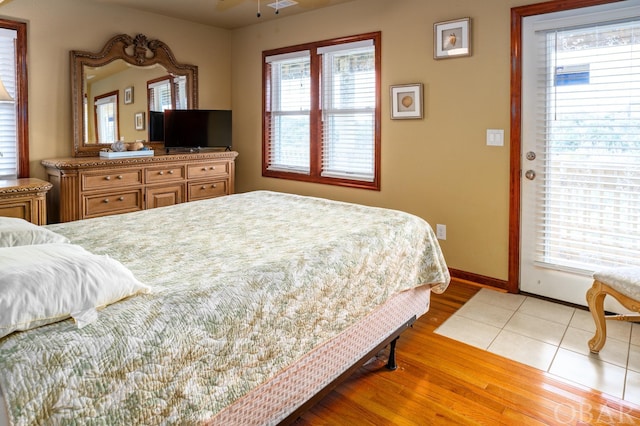 bedroom with light wood-type flooring, visible vents, and baseboards