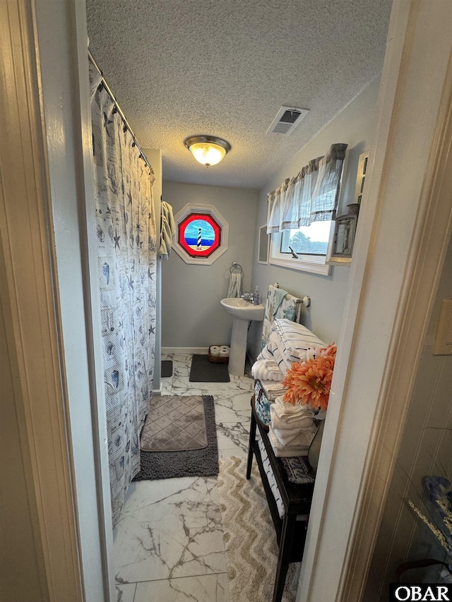 524 Aydlett Rd, Aydlett, NC 27916 - bathroom with a textured ceiling and a shower with curtain