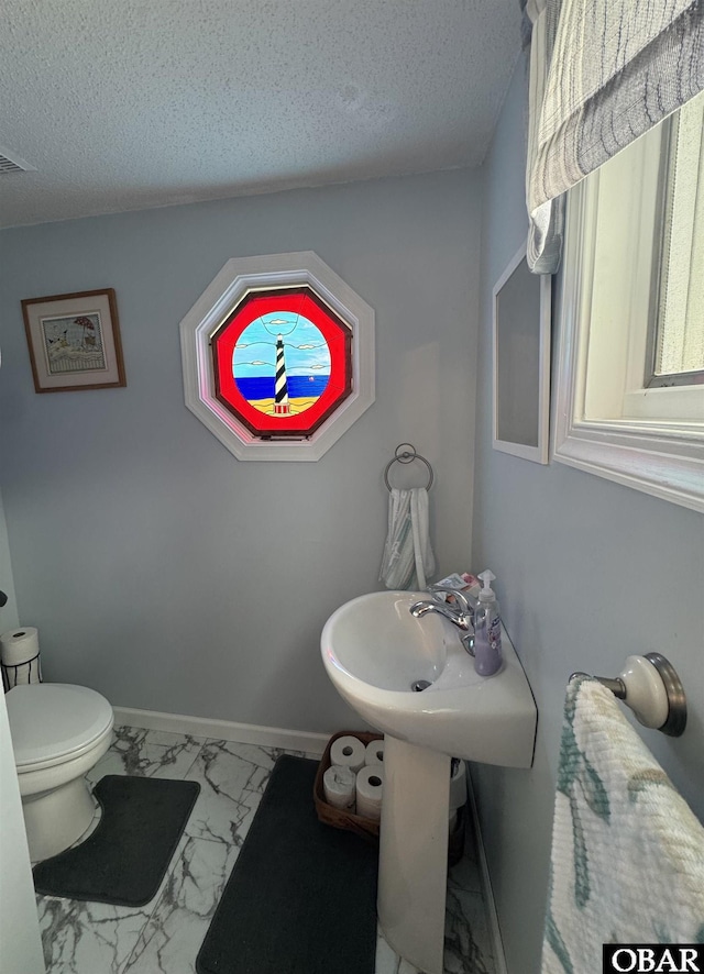 524 Aydlett Rd, Aydlett, NC 27916 - bathroom featuring marble look tile flooring and a textured ceiling