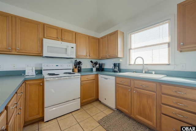 kitchen featuring light tile patterned floors, white appliances, a sink, light countertops, and brown cabinets