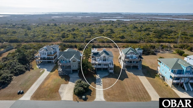 bird's eye view featuring a wooded view and a residential view