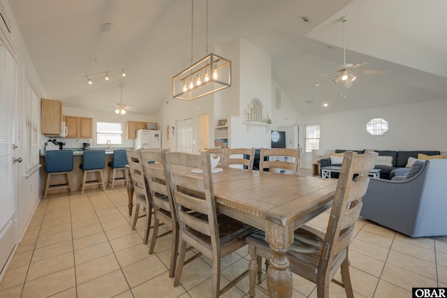 dining room with light tile patterned floors, ceiling fan, and high vaulted ceiling