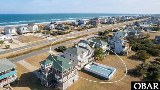 drone / aerial view featuring a water view and a residential view