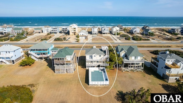 drone / aerial view with a water view and a residential view