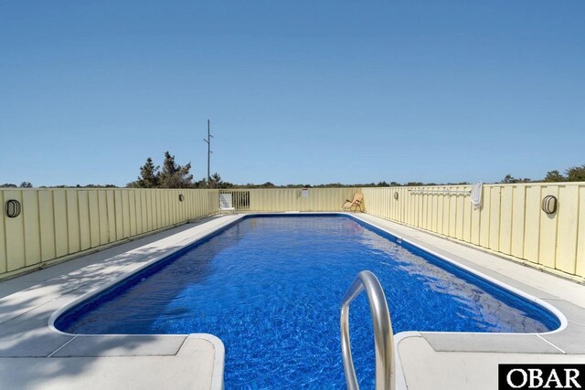 view of swimming pool with a fenced in pool and a fenced backyard