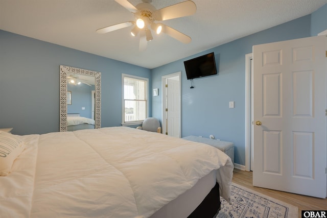 bedroom with light wood-style floors and ceiling fan