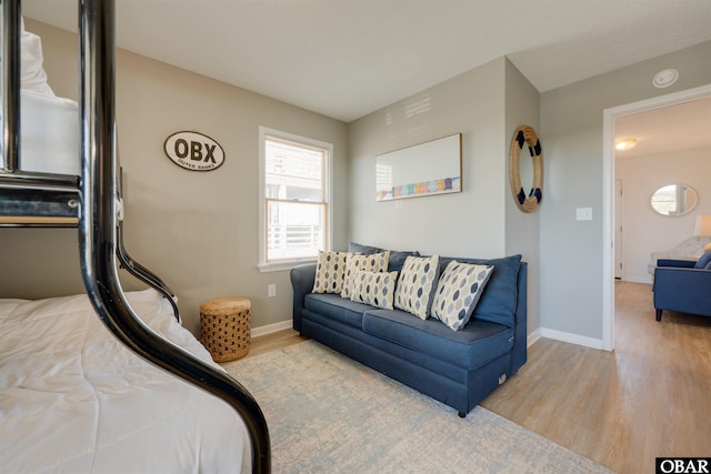 bedroom with baseboards and wood finished floors