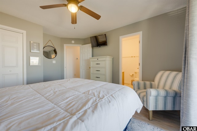 bedroom featuring ceiling fan, wood finished floors, and connected bathroom