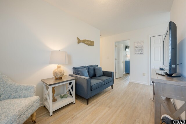 sitting room with light wood-style floors and baseboards